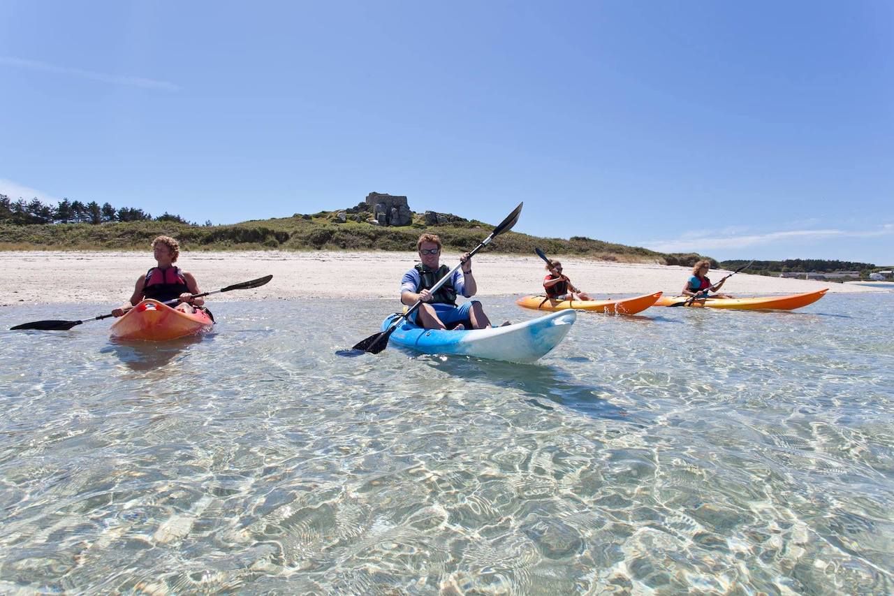 Kayaks in clear water on the Isles of Scilly