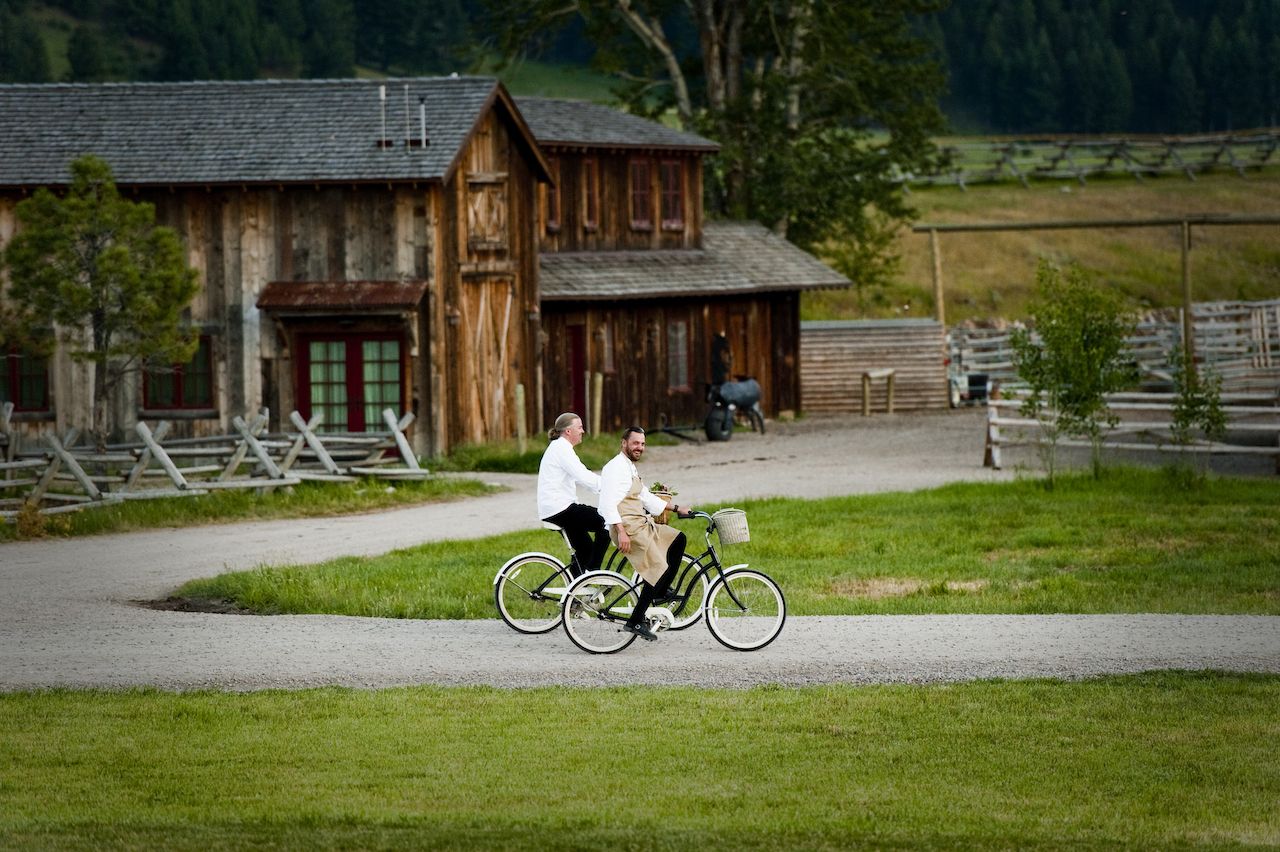 Two chefs riding bicycles along a path at The Ranch at Rock Creek