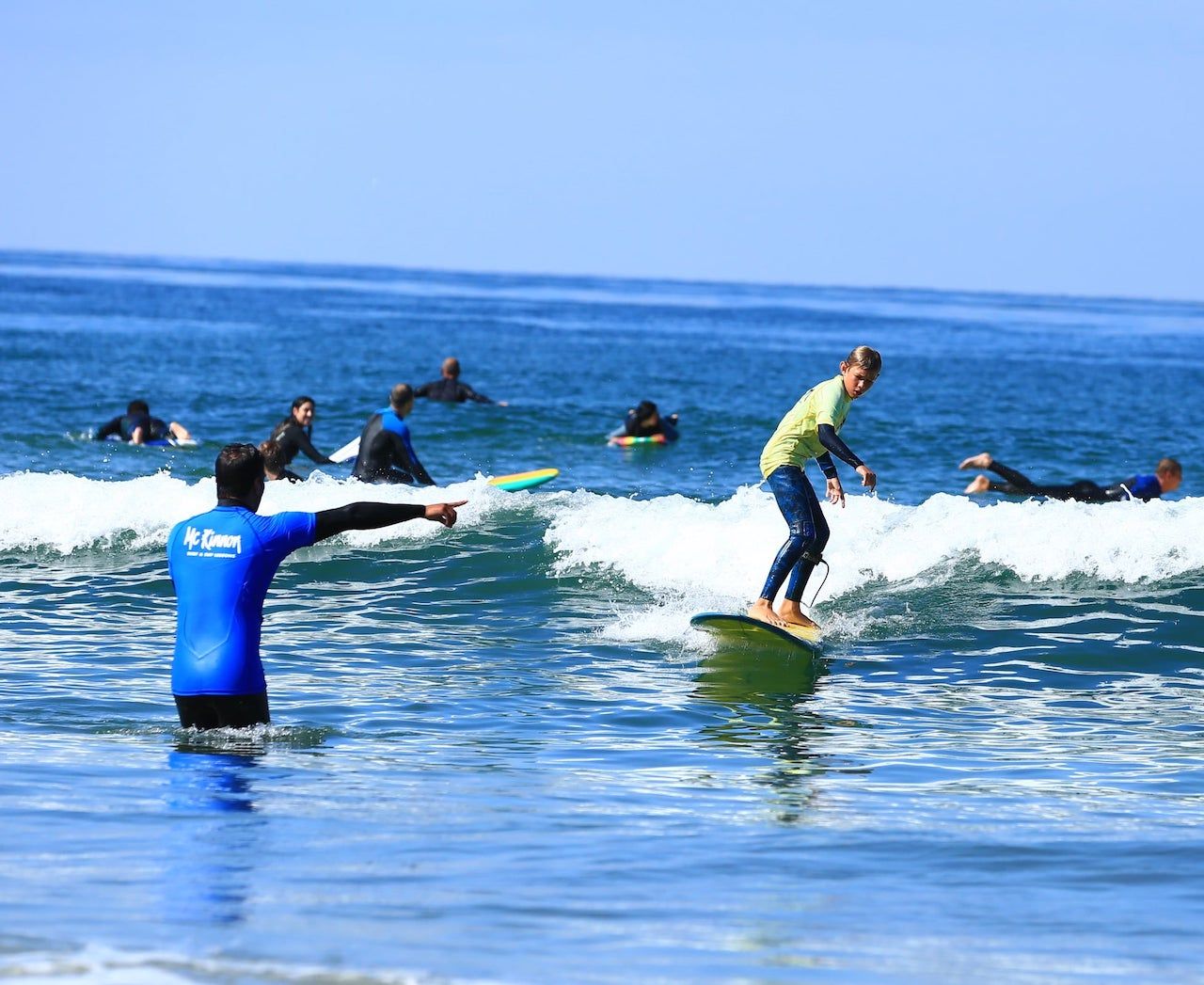 Instructor teaching a surfer