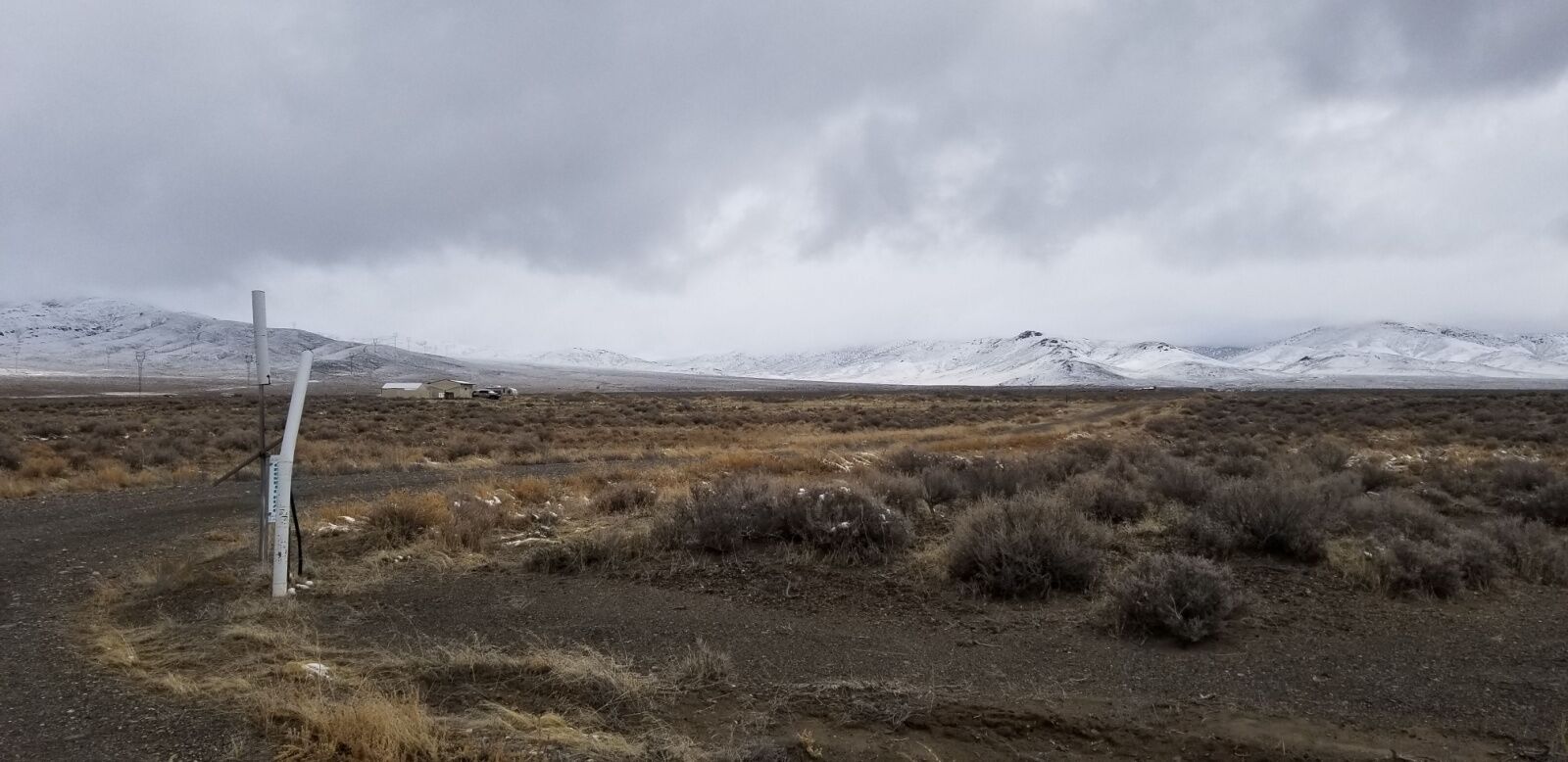 kyle hot springs in nevada with snow on mountains in back 