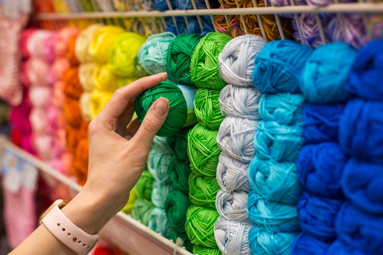 person purchasing yarn for a knitting project