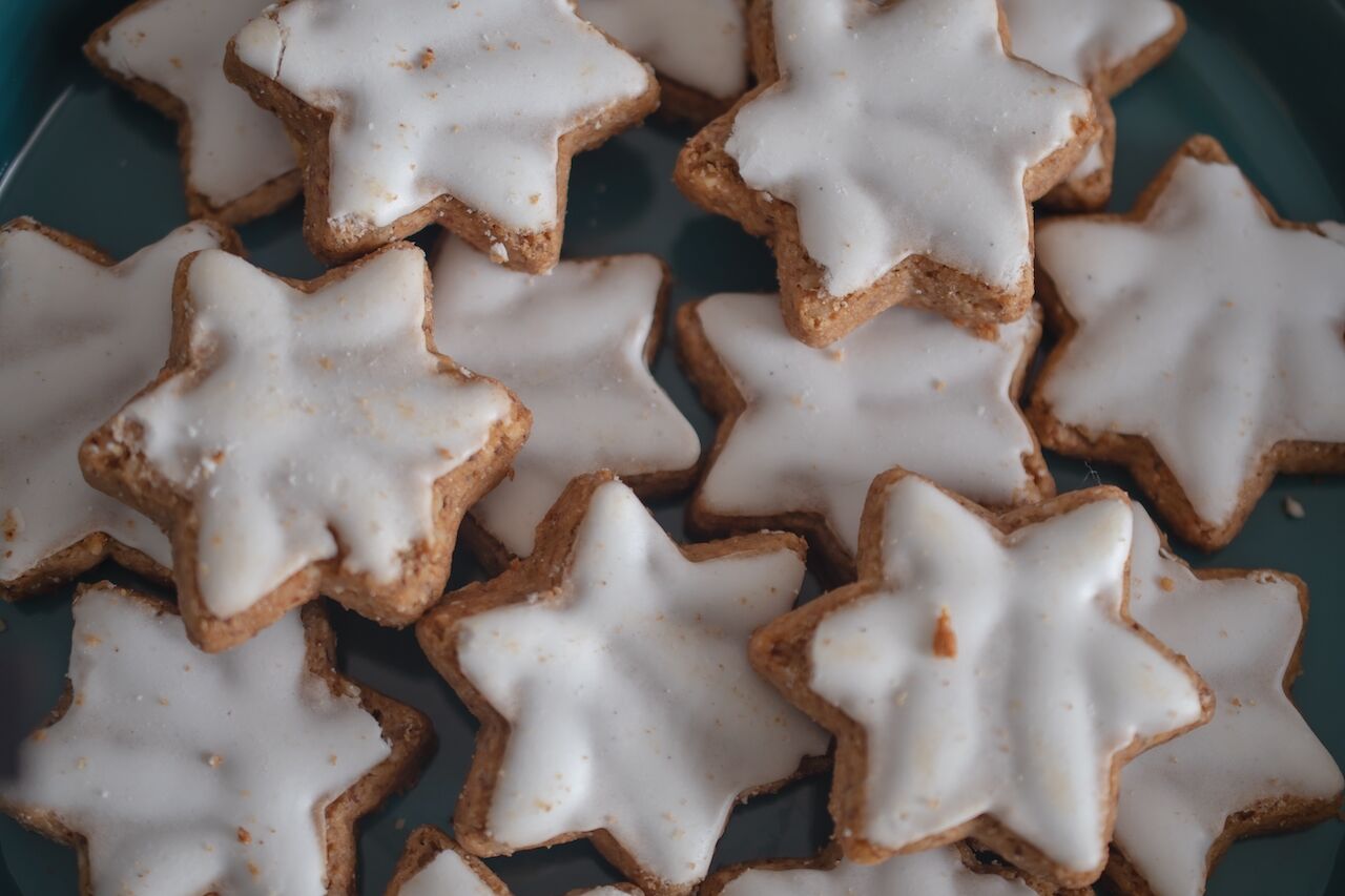 zimtsterne are a star shaped german christmas cookie with  a sugar glaze
