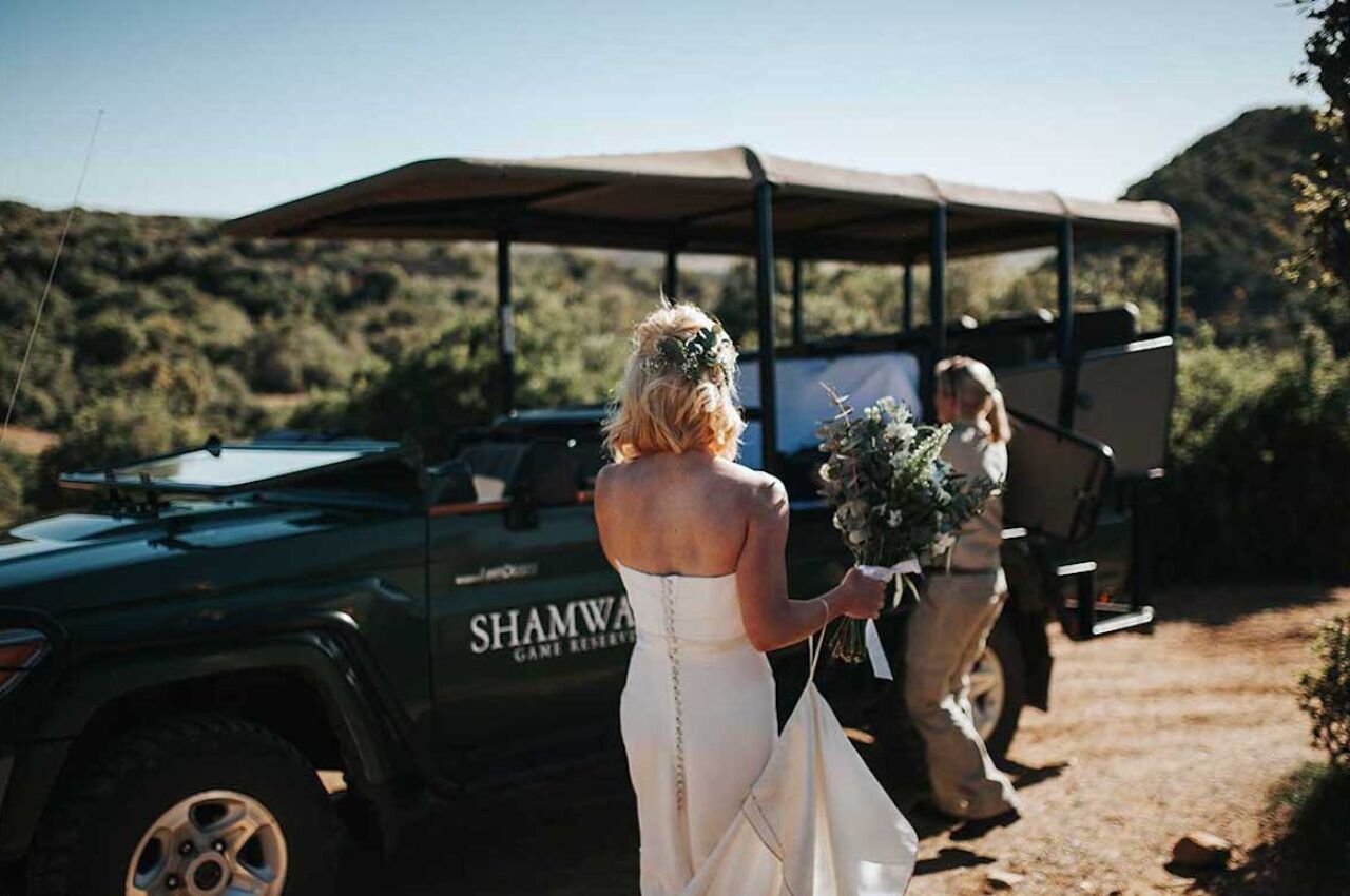 Bride walks to safari van during one of the best destination weddings