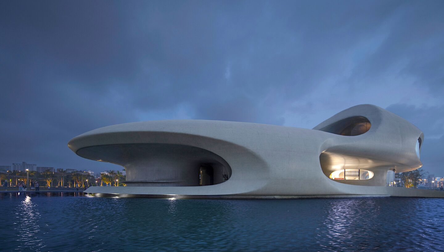This library located in China has views of the South China Sea and is a curvy concrete building.