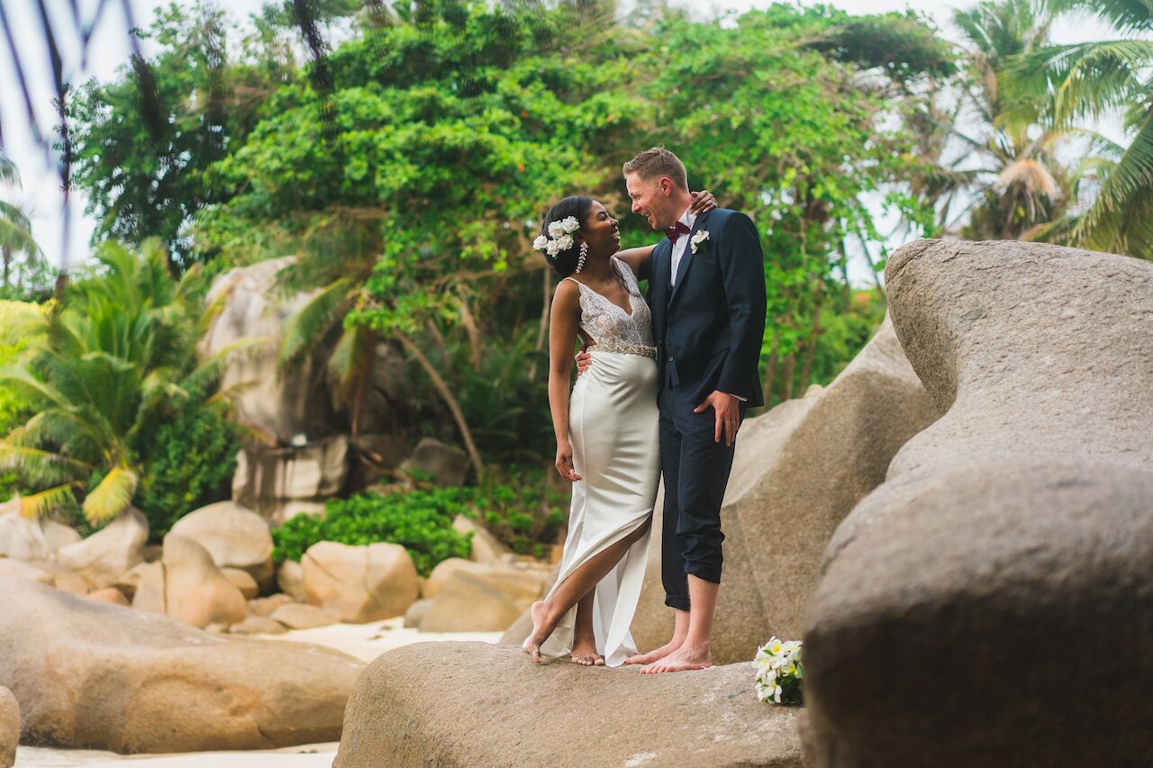 Couple pose for photos in destination wedding in the Seychelles