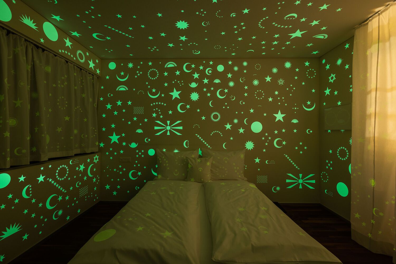 Pop-up hotel room in Zurich Switzerland decorated with glow-in-the-dark celestial bodies