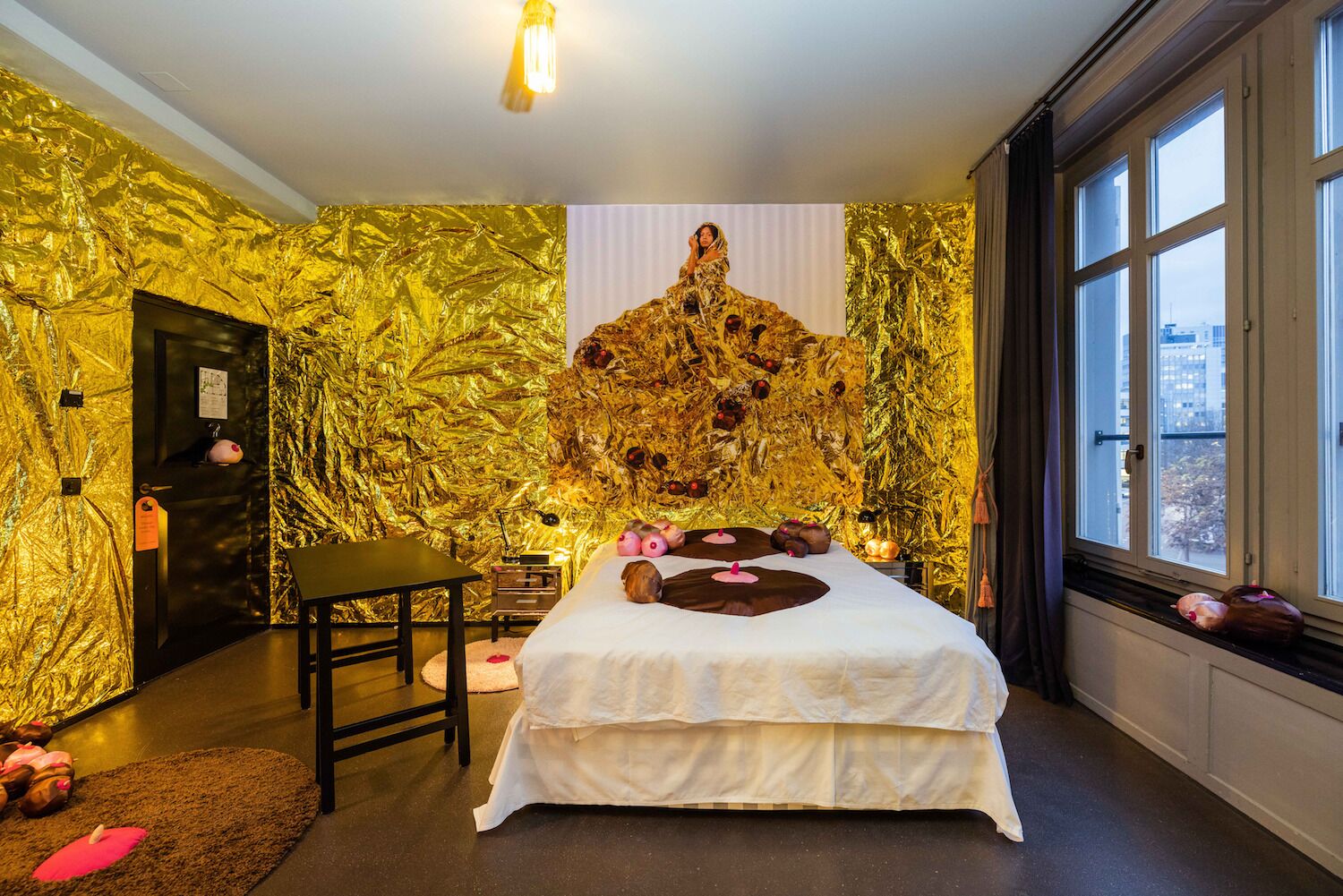 Pop-up hotel room in Zurich Switzerland decorated with nipple cushions and gold leaves on the walls