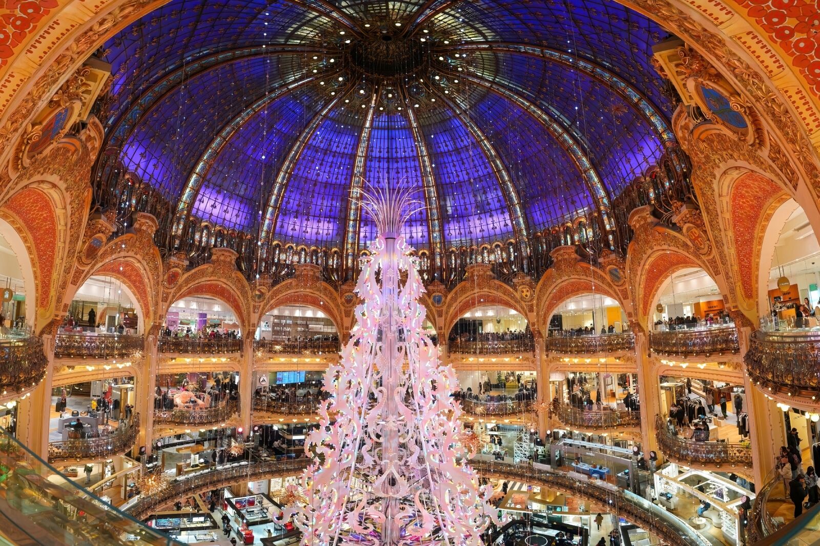 Giant christmas tree under the glass dome of the Galeries Lafayette department store on the Boulevard Haussmann in Paris, France