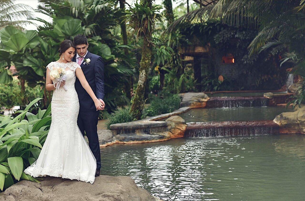 Bride and groom standing near a pool in Costa Rica
