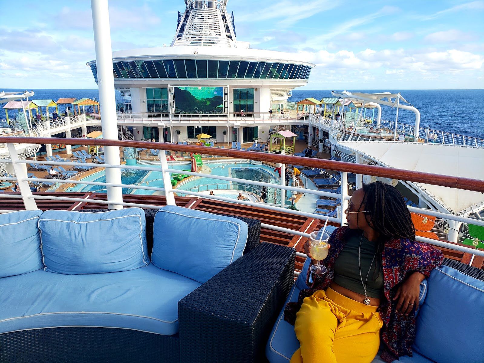Tshego Letsoalo sips a cocktail on the deck of the Navigator of the Seas, a brand-new cruise ship. Tshego took a cruise during Omicron.