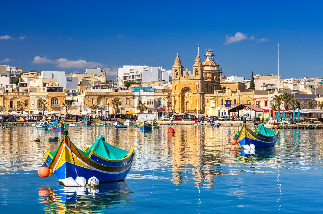 Colorful boats in the harbour in Malta a gay travel destination for 2022