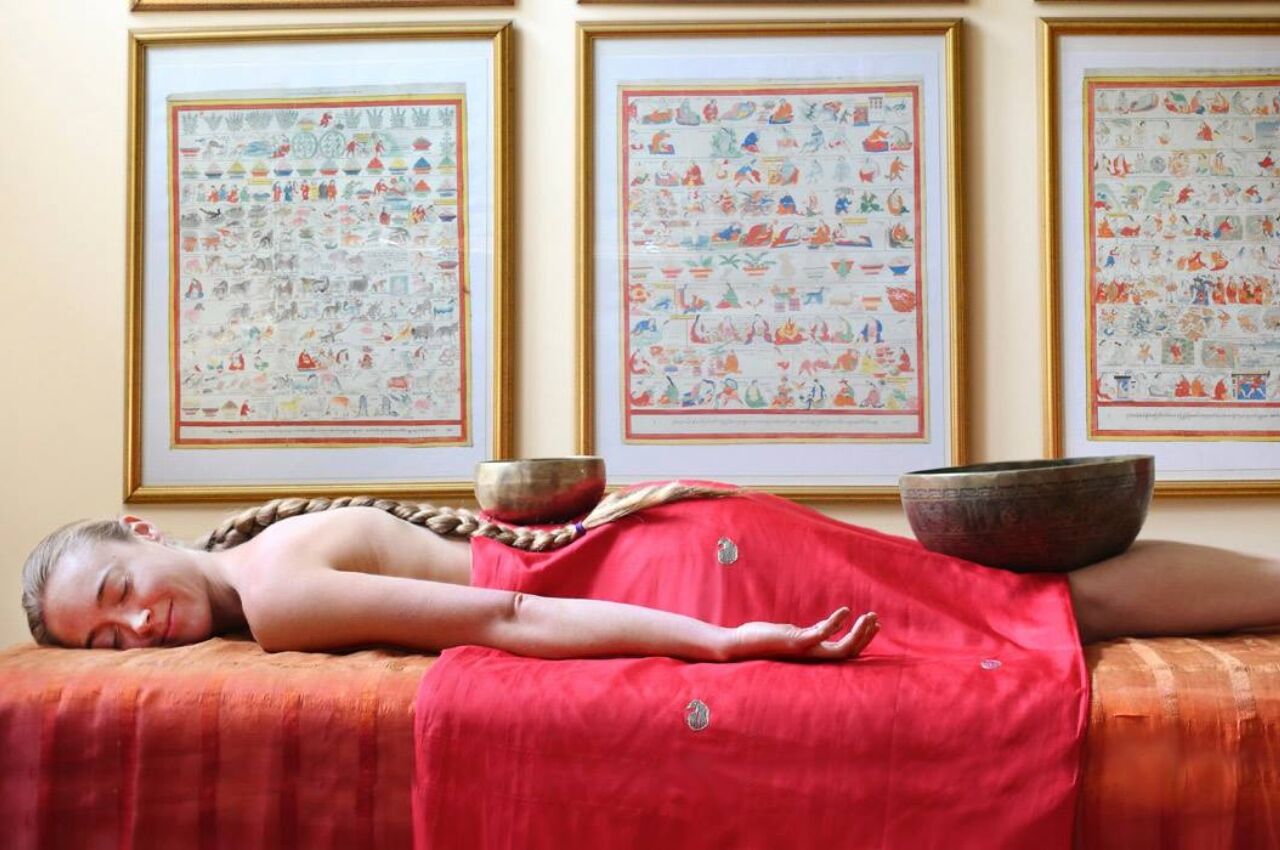 Woman on bed during a Sound bathing health retreat in the US