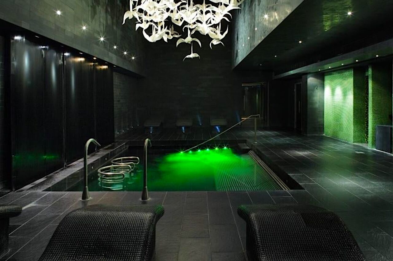Green lit indoor hotel pool at g Hotel in Galway Ireland