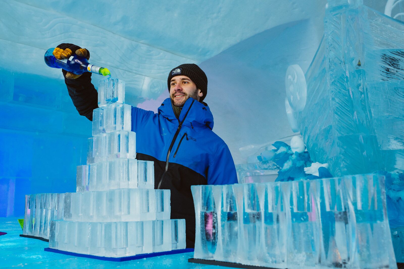Photo: man pouring champagne at an ice hotel bar (where there are no ice hotel toilets, just regular toilets)