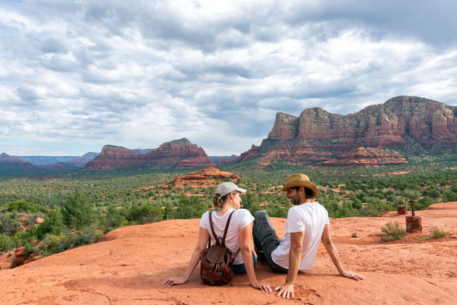 couple looking at beautiful mountains landscape. couple on hiking trip enjoying view of Sedona, Arizona,