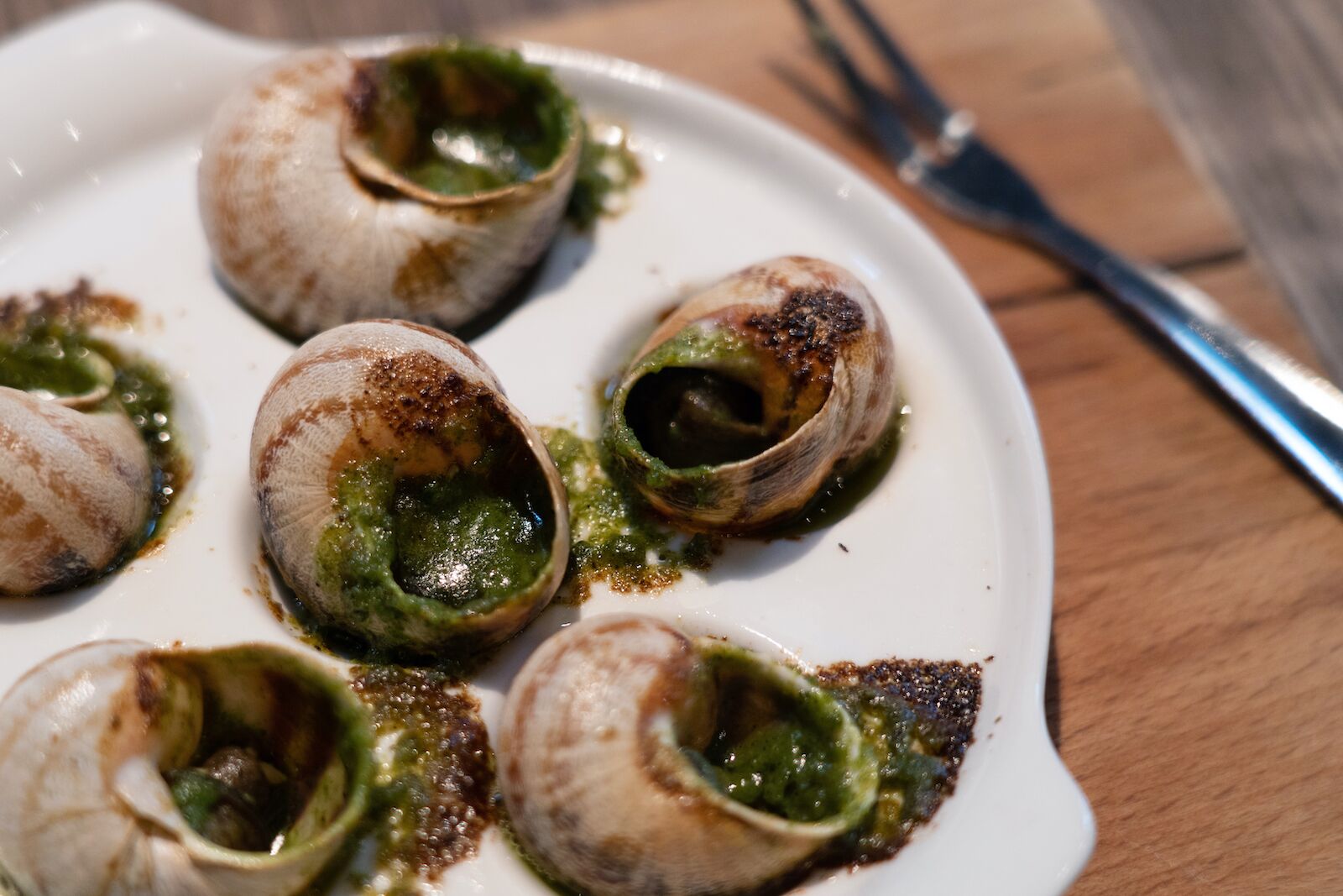 Escargots de Bourgogne or  Snails with garlic herbs butter on the wooden table