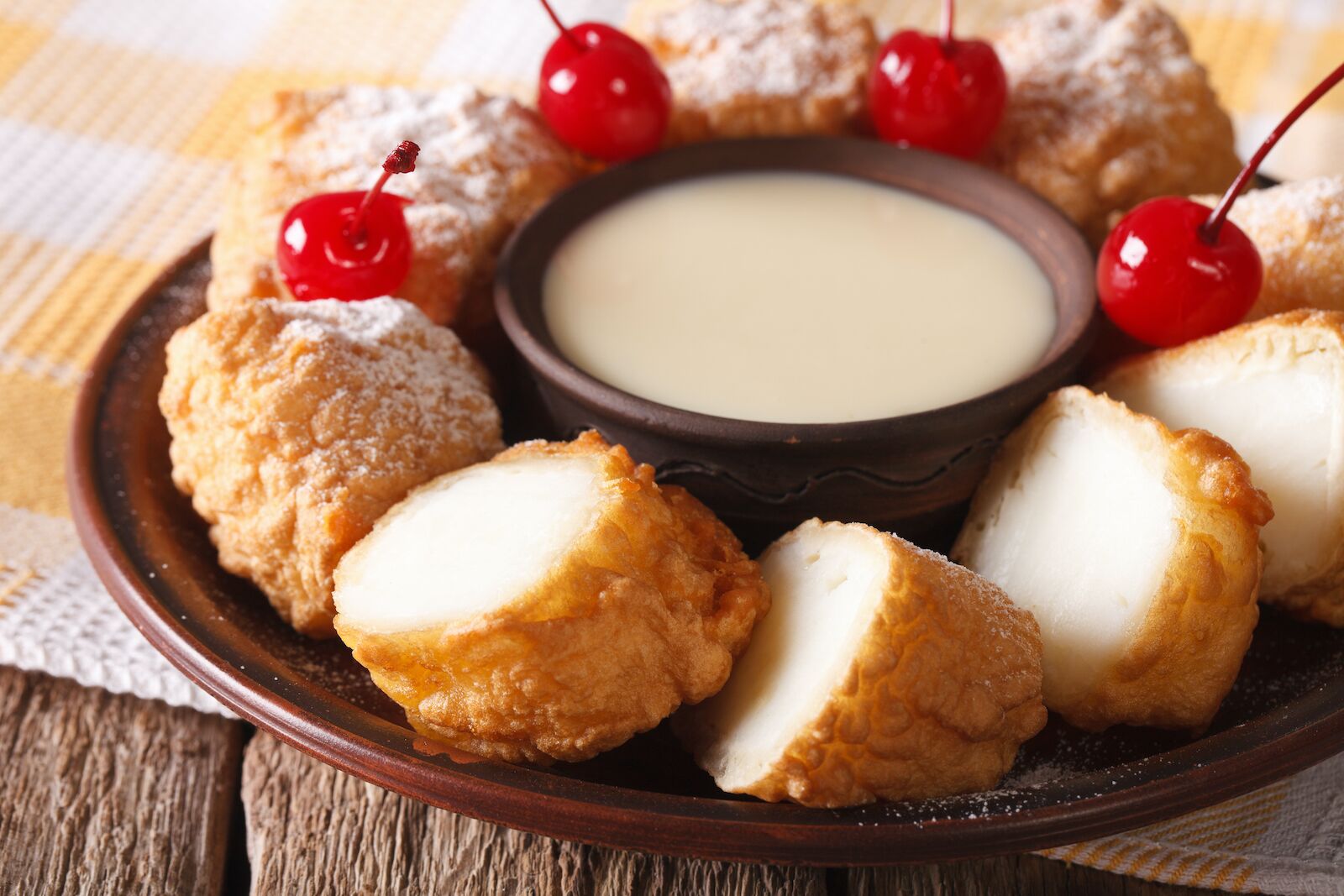 Leche frita with condensed milk and cherries on a plate 