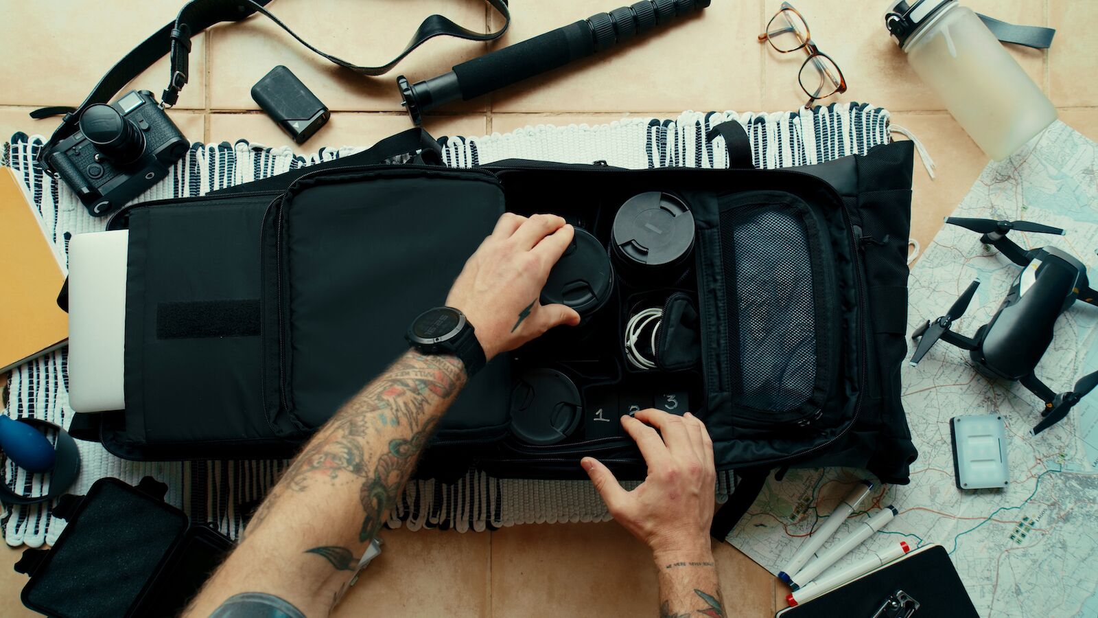 Professional photographer packing their camera gear with caution to keep their valuables safe when traveling