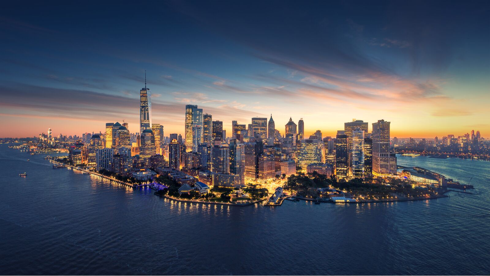 Panoramic view of New York at sunrise. Manhattan office buildings / skyscrapers in the morning., where to travel