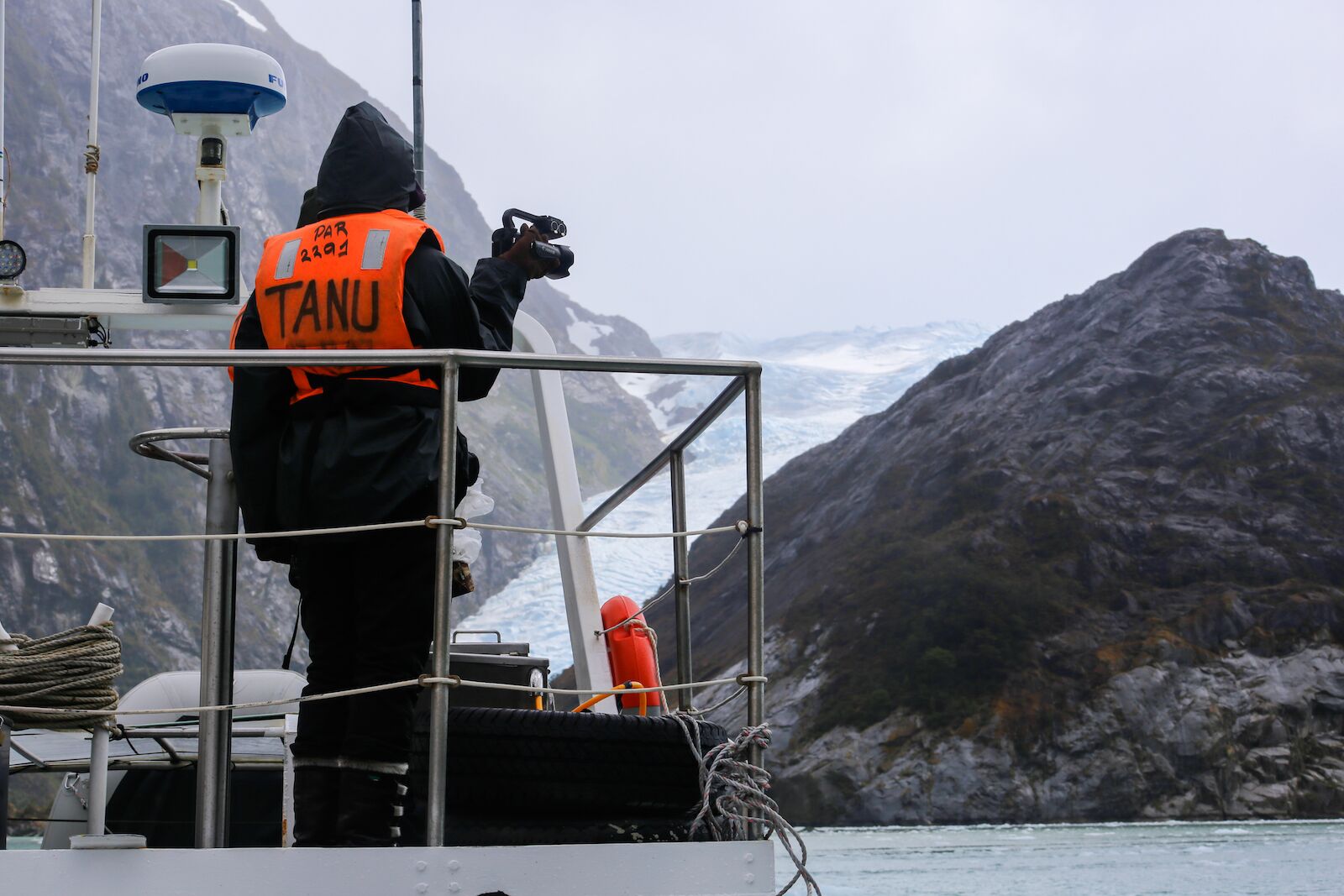 A person engaging in wildlife tourism in front of the santa ines glacier 