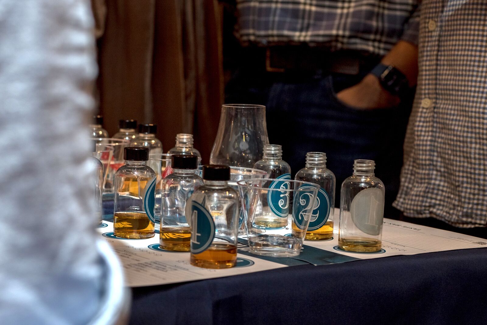 blind tasting event with bottles of unlabeled single malt whiskey