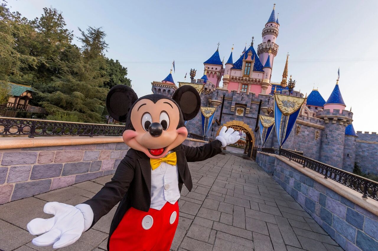 Micky Mouse in front of sleeping beauty castle at Disney 