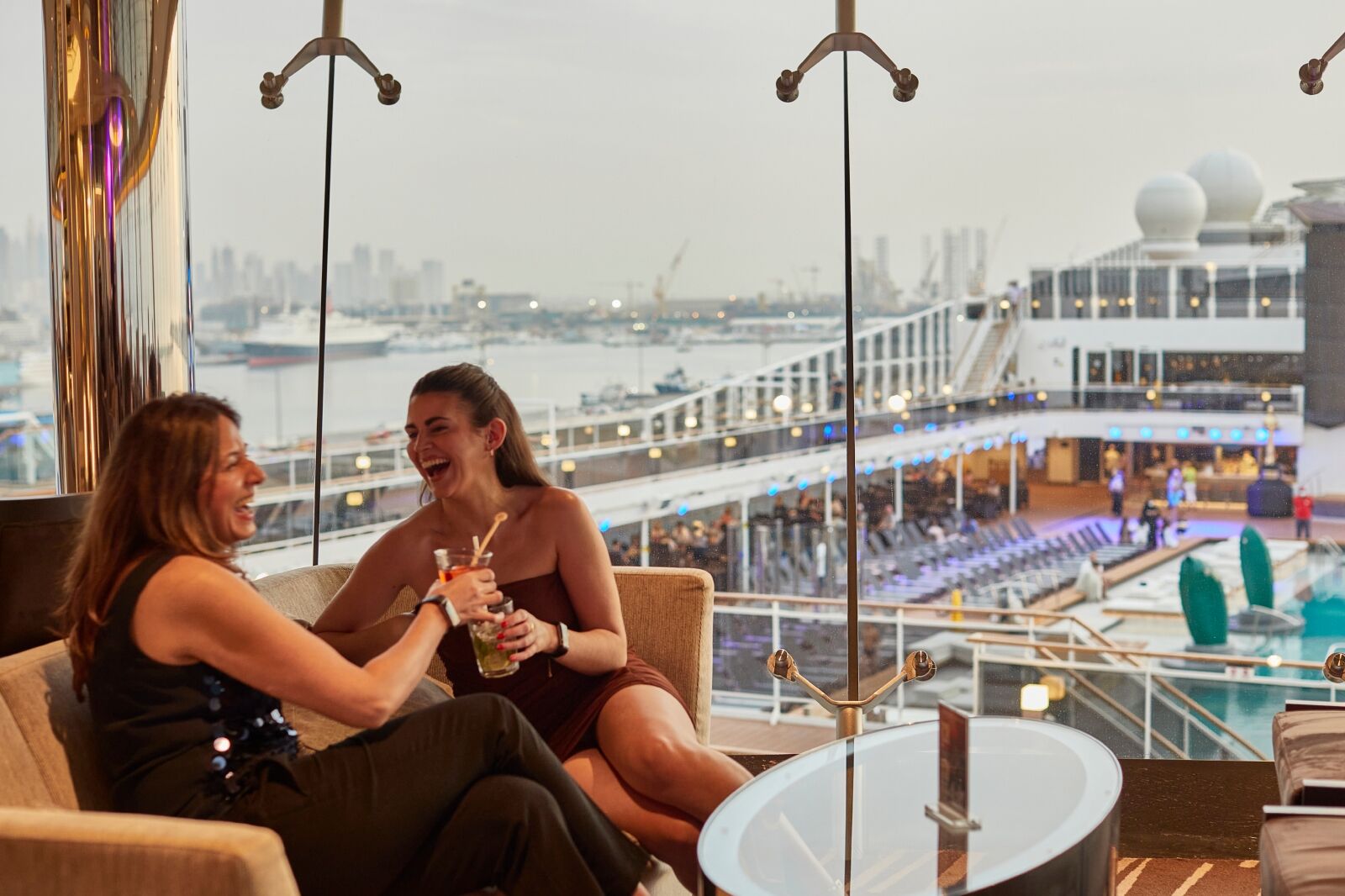 Couple on couch drinking from cruise line drink packages on MSC 