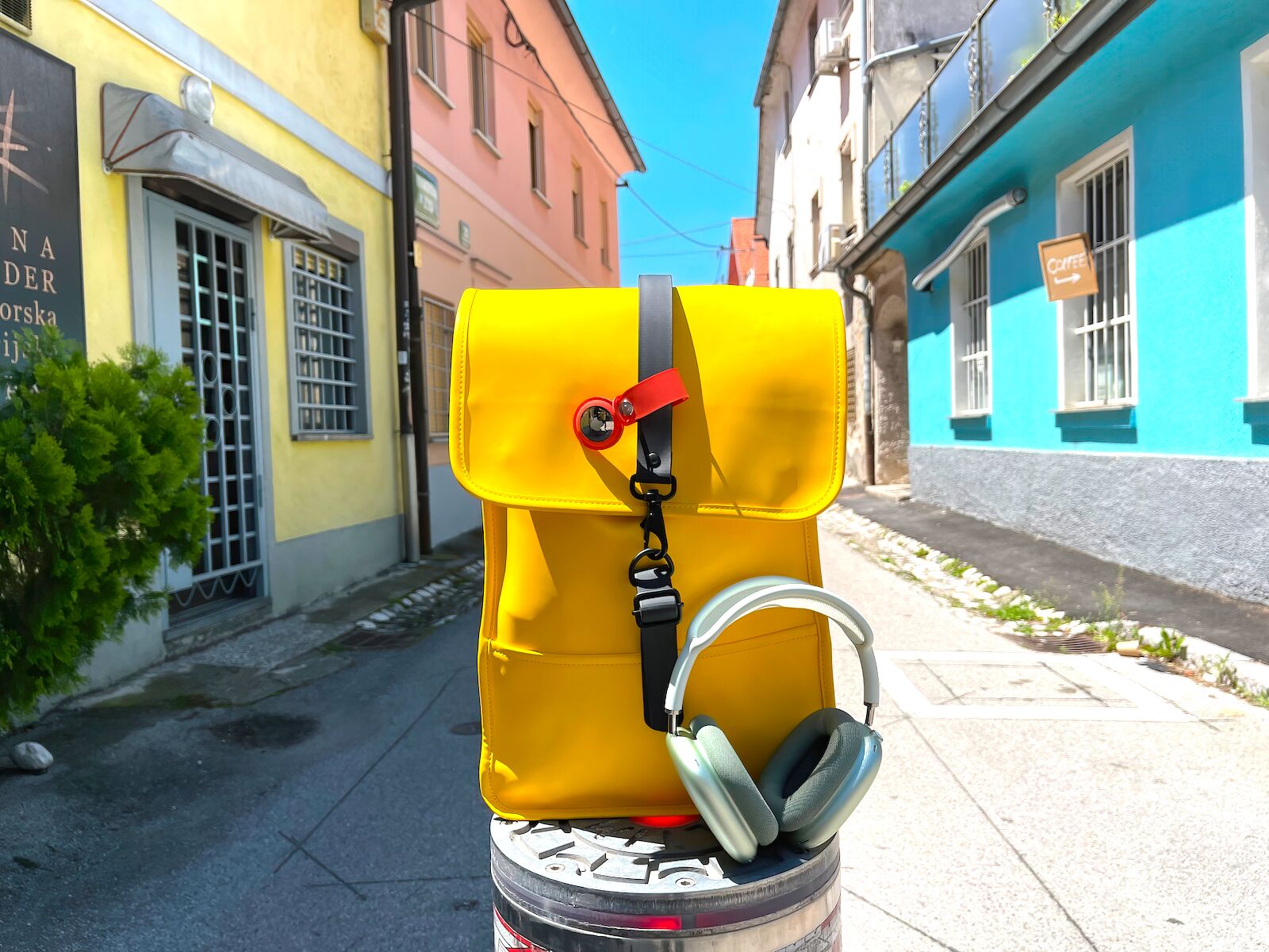 Yellow bag with an AirTag attached to it. AirTags should be an essential part of any frequent traveler's kit