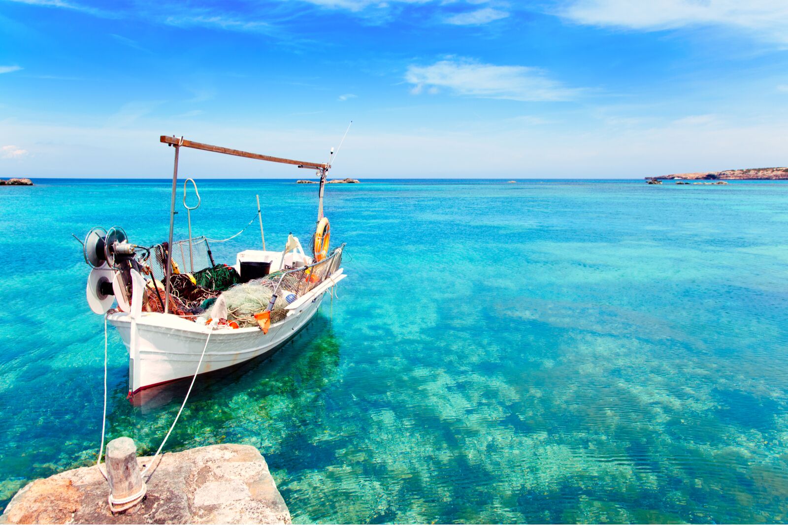 view of crystal blue water with a small boat
