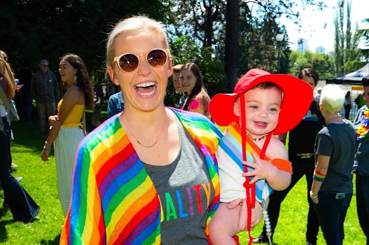 Woman with baby dressed in rainbow colors for Pride in Seattle