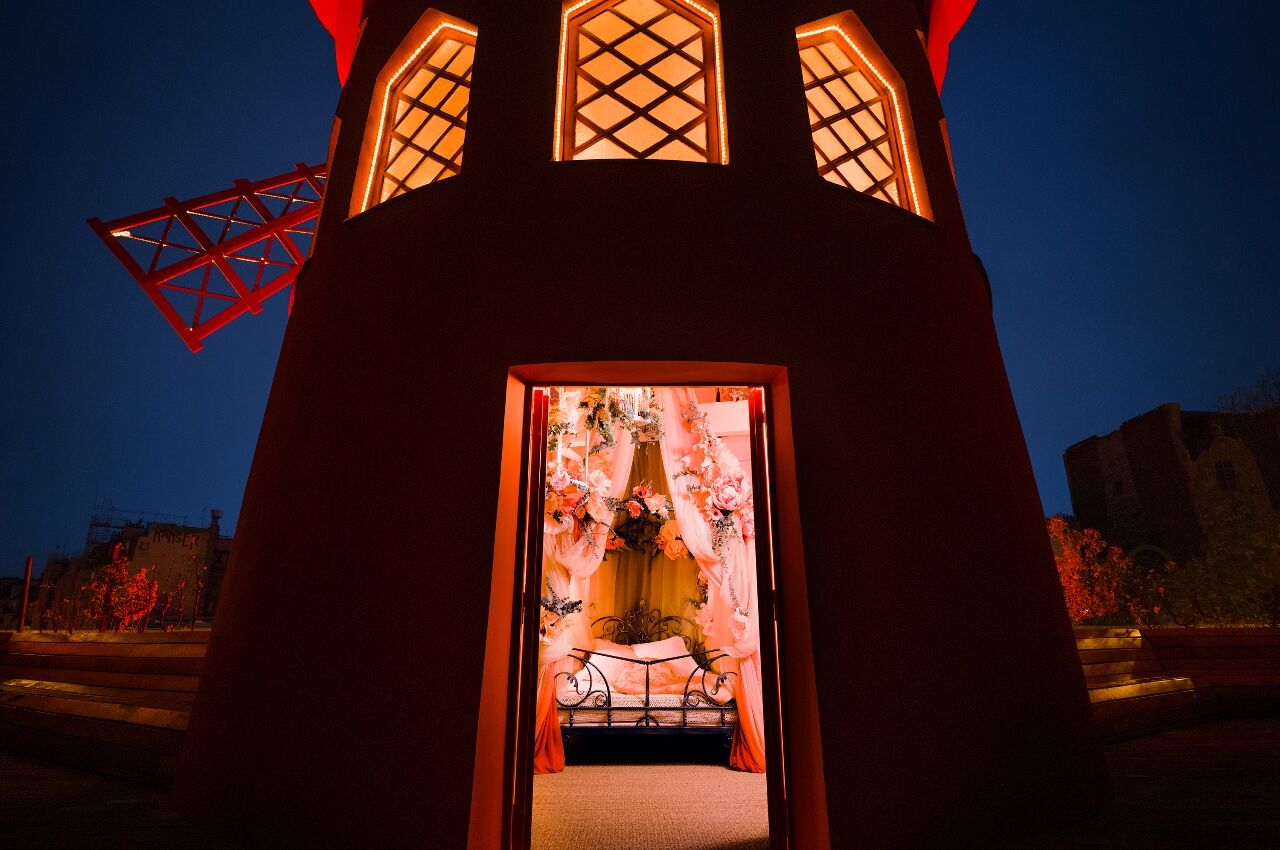 Moulin Rouge Airbnb windmill at night with door open