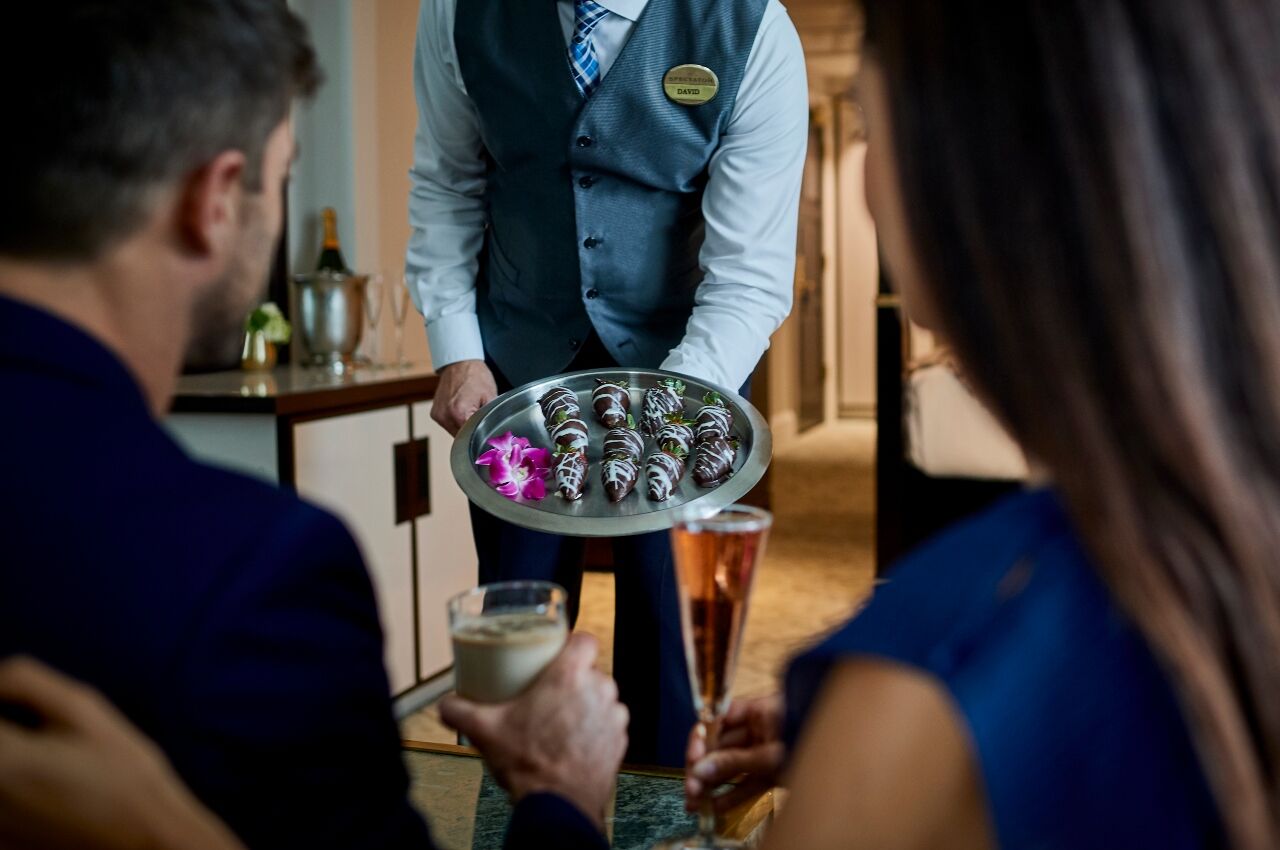 Butler delivers chocolate-covered strawberries at The Spectator Hotel