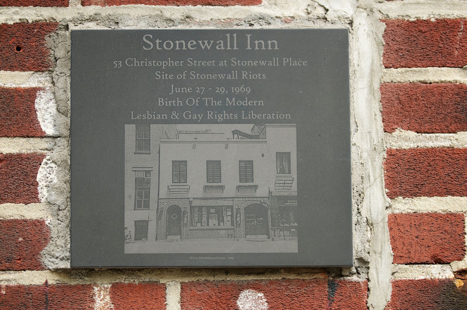 NEW YORK CITY - AUGUST 26, 2011: A memorial plaque hangs on the Stonewall Inn on Christopher Street, the site of the Stonewall riots of 1969, a catalyst for the gay liberation movement.