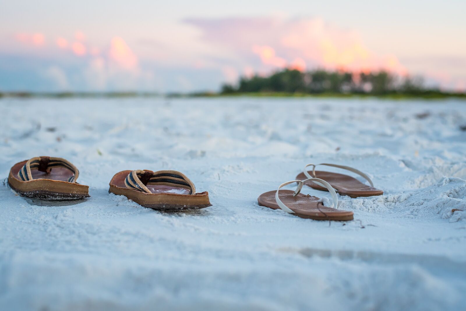 Sandals on the Beach Sand  at Sunrise