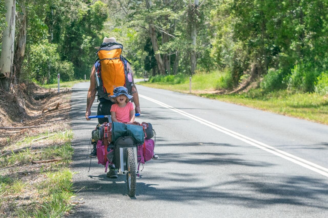 Young girl on back of bikebackpacking with kids
