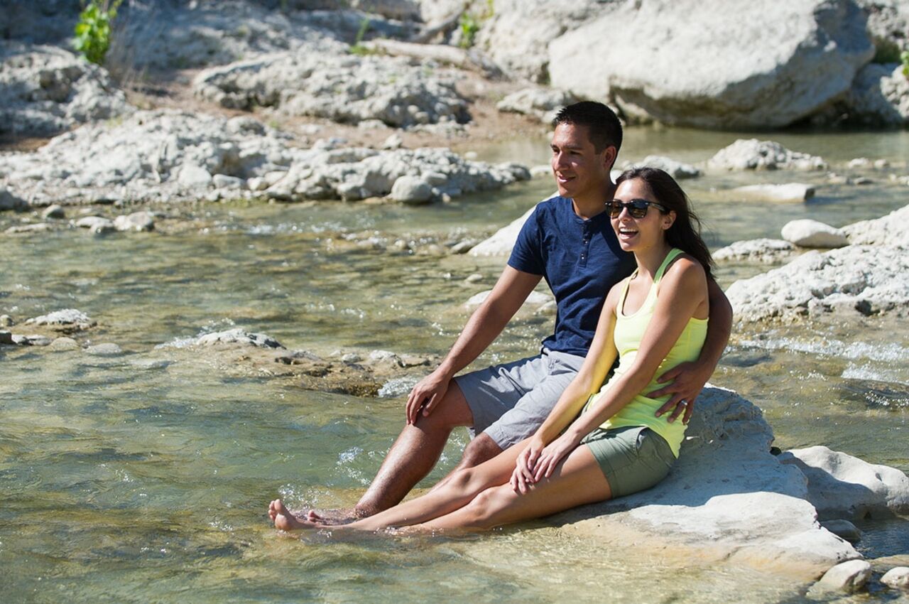 Couple by water in Pedernales Falls Texas state park