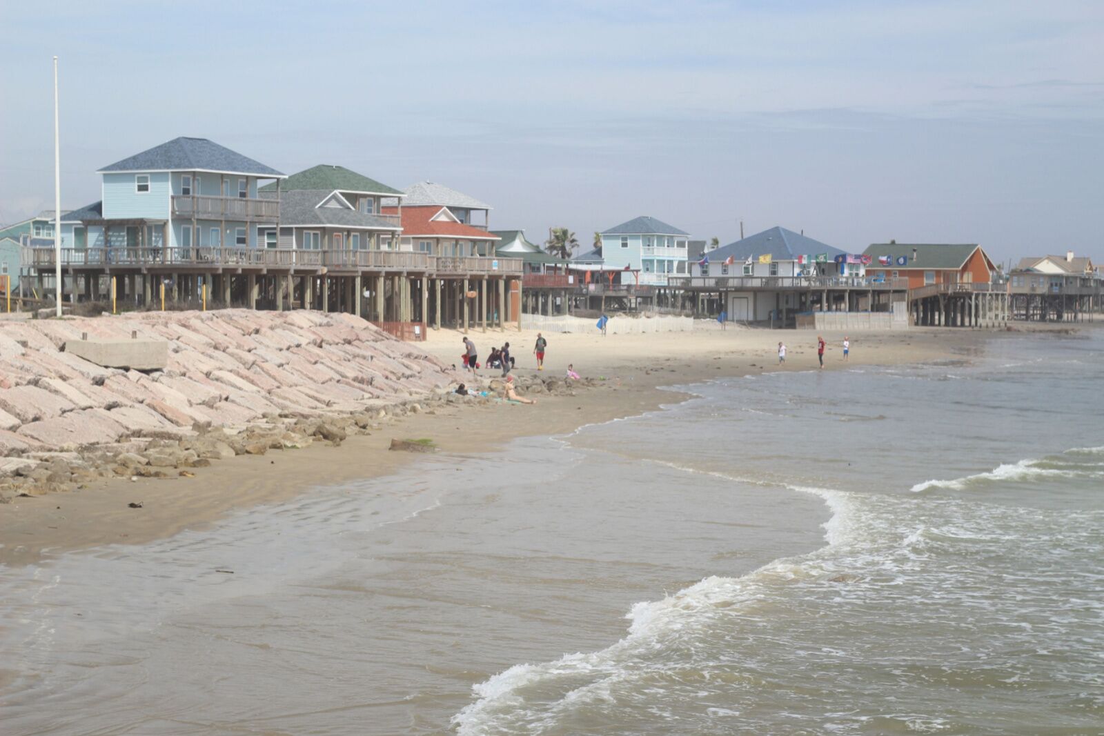 Beach view with people and beach homes