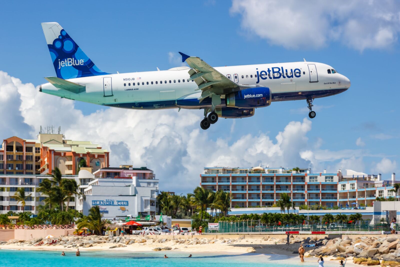 JetBlue plane flying over beach