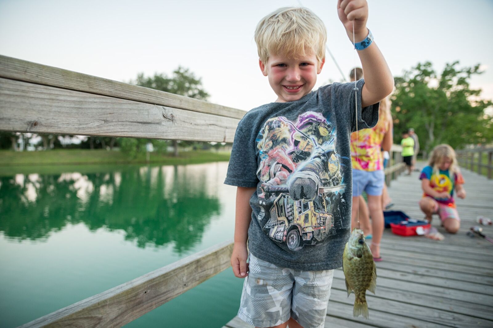 Boy with fish while camping in houston