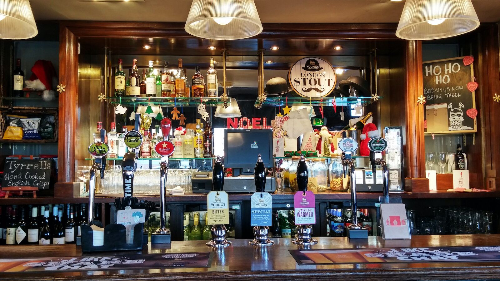 interior of English pub-view of beer taps with signs-English pub rules