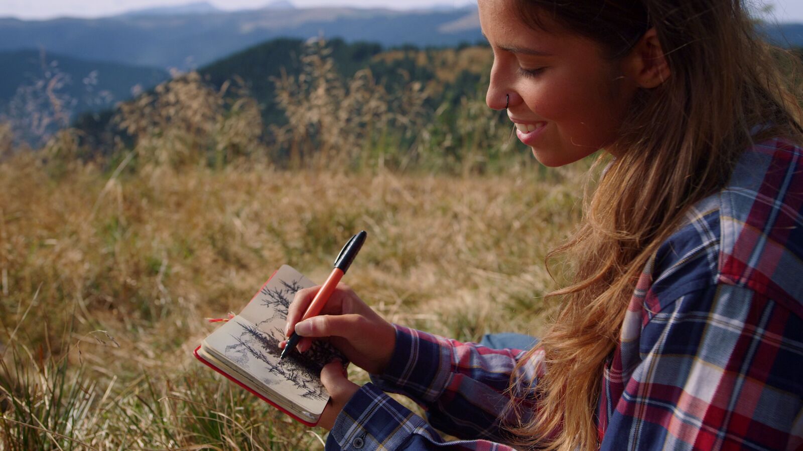 hiking for beginners - woman sketching in notebook