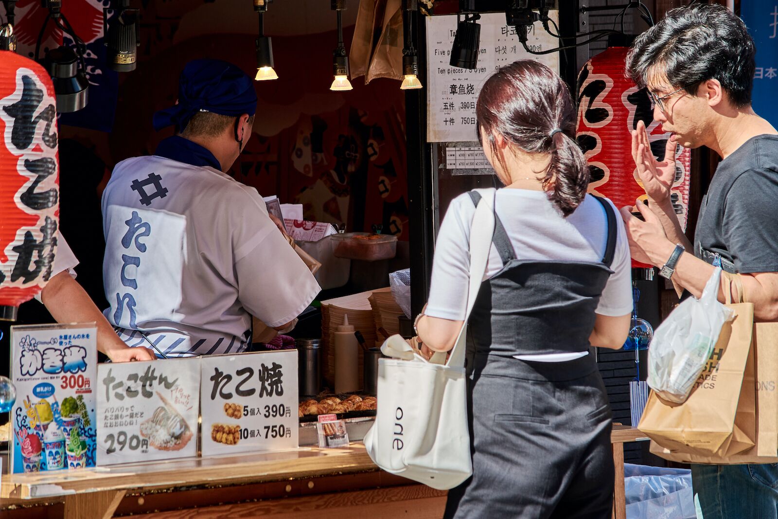 two people in line outside a street food vendor in japan