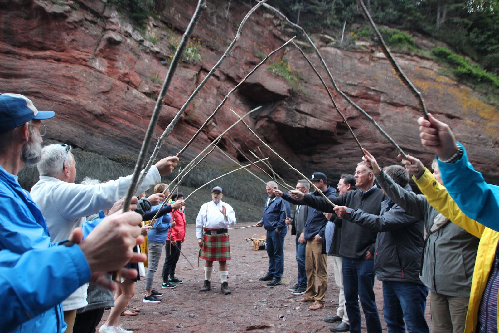 end of dinner dance with guests holding up sticks and chef in the background - savour the sea caves