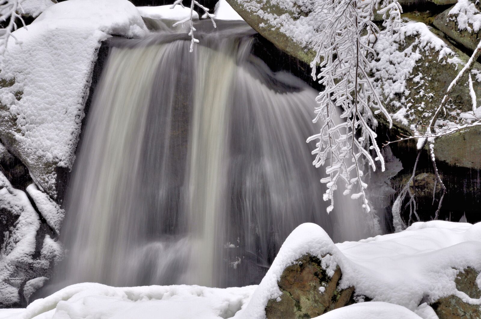 Winter scene in Willard Brook State Park, Massachusetts. Small waterfall (Trap Falls) framed by fresh fallen snow.