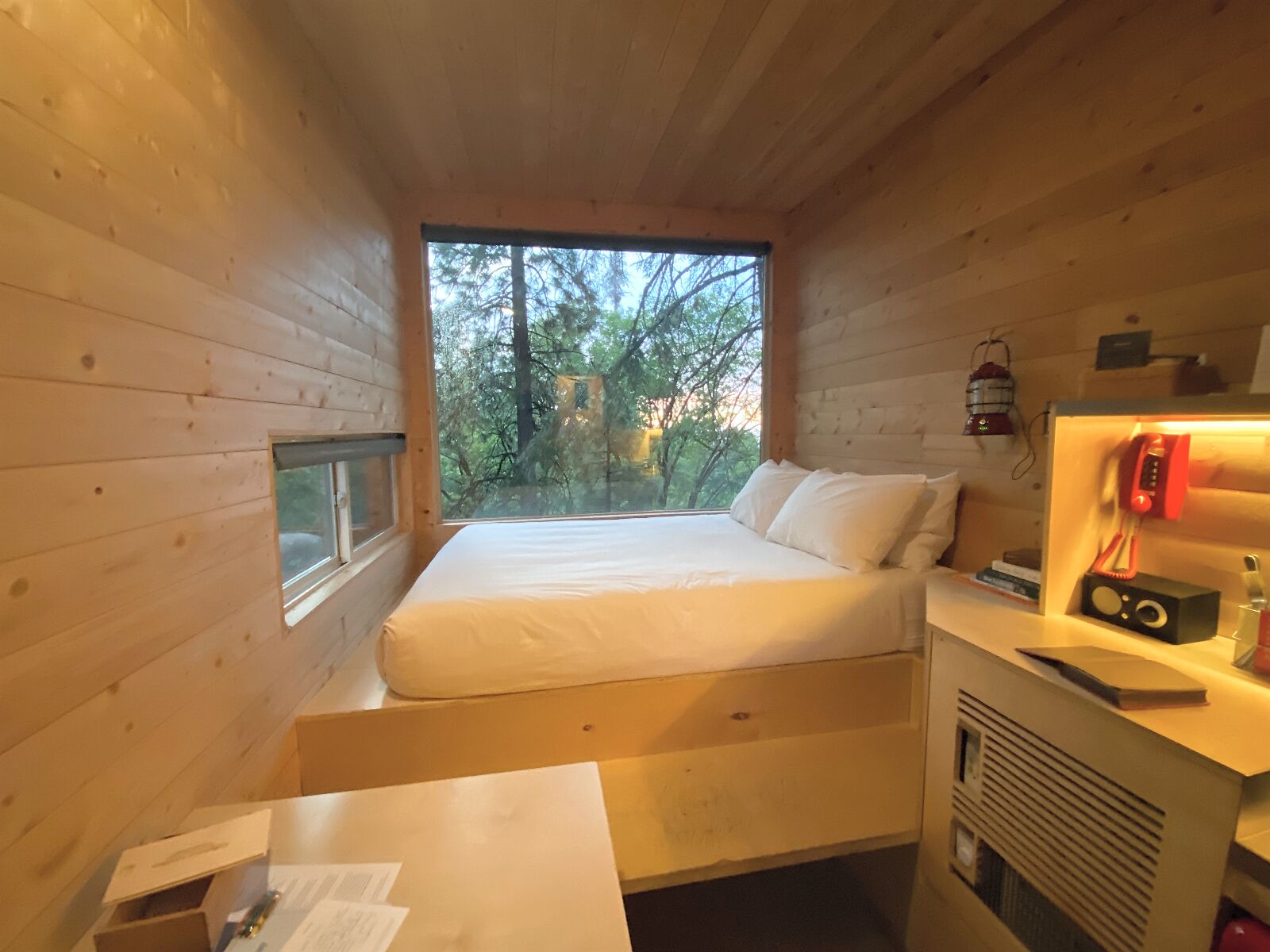 Getaway House, inside of Tiny Cabin with big bed over giant indow