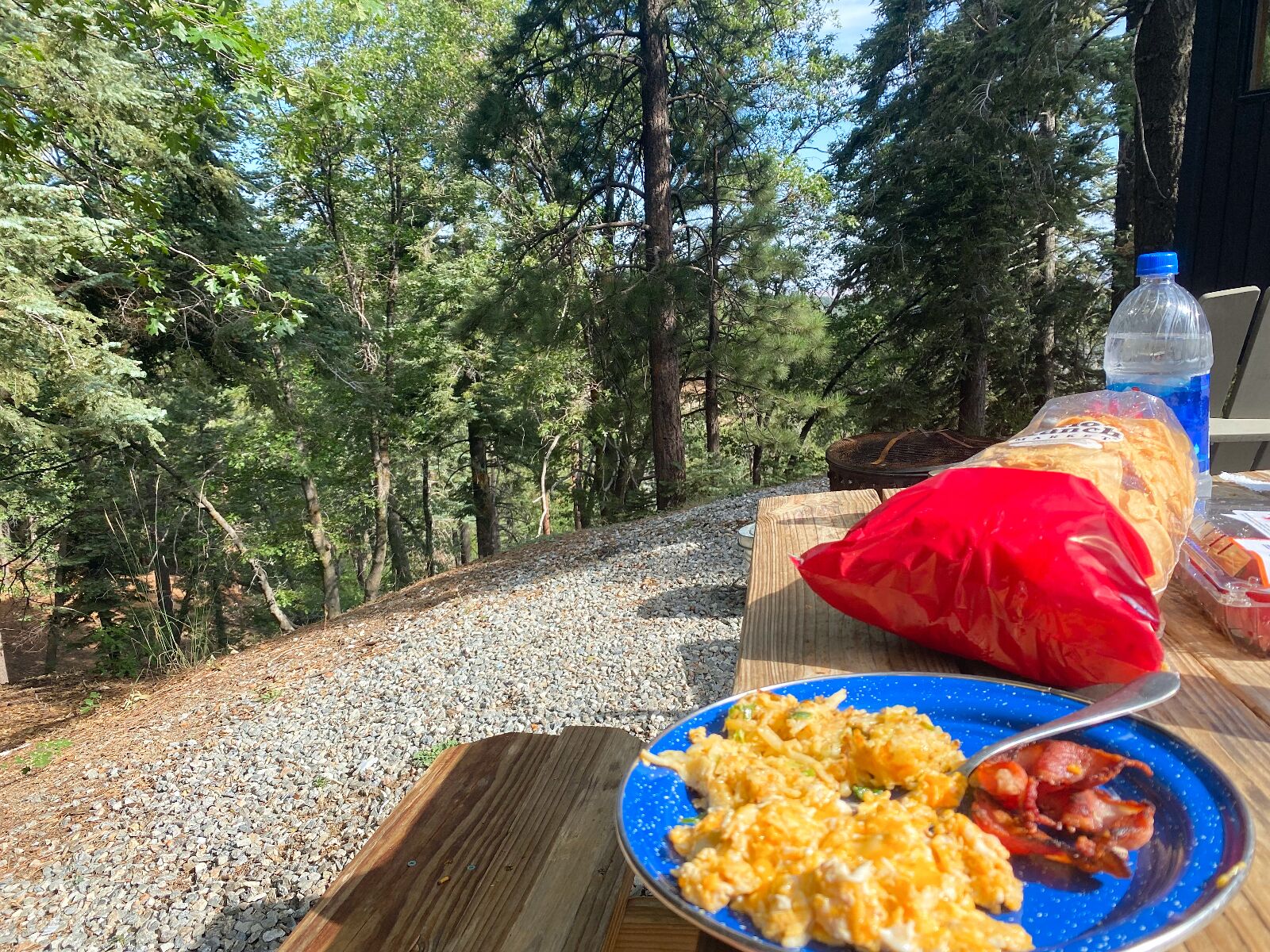 Getaway House, picnic table with breakfast of chips, salsa, eggs, and bacon