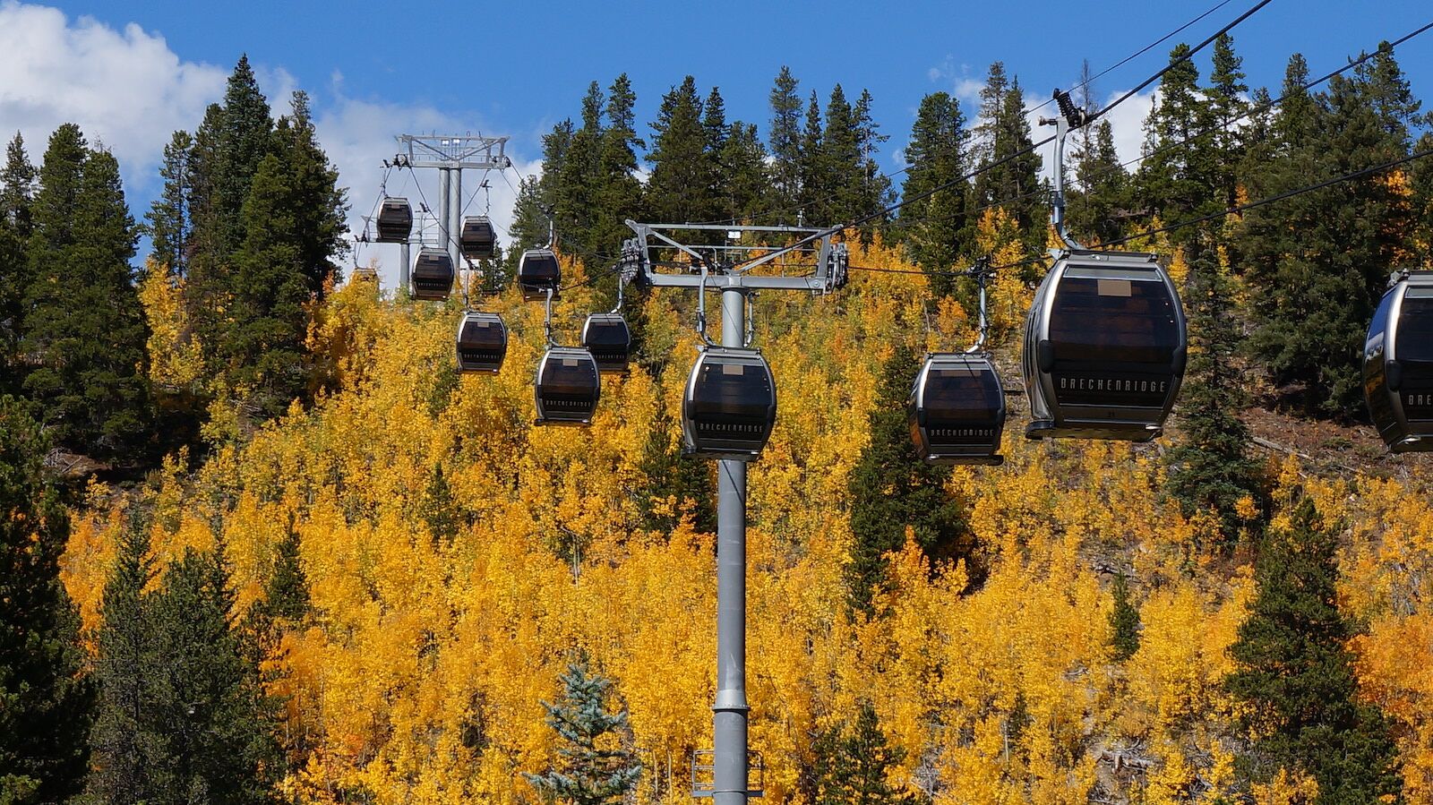 gondolas over aspen trees in the fall in breckenridge colorado