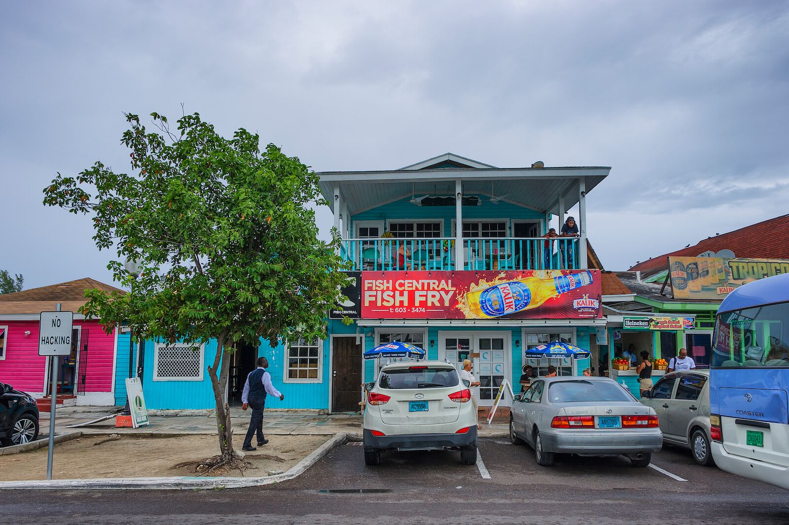 Nassau, Bahama - September 21/2019: Views of Arawak Cay Fish Fry village,of hand painted colorful structures providing Caribben fish food and drinks along the beach shore.