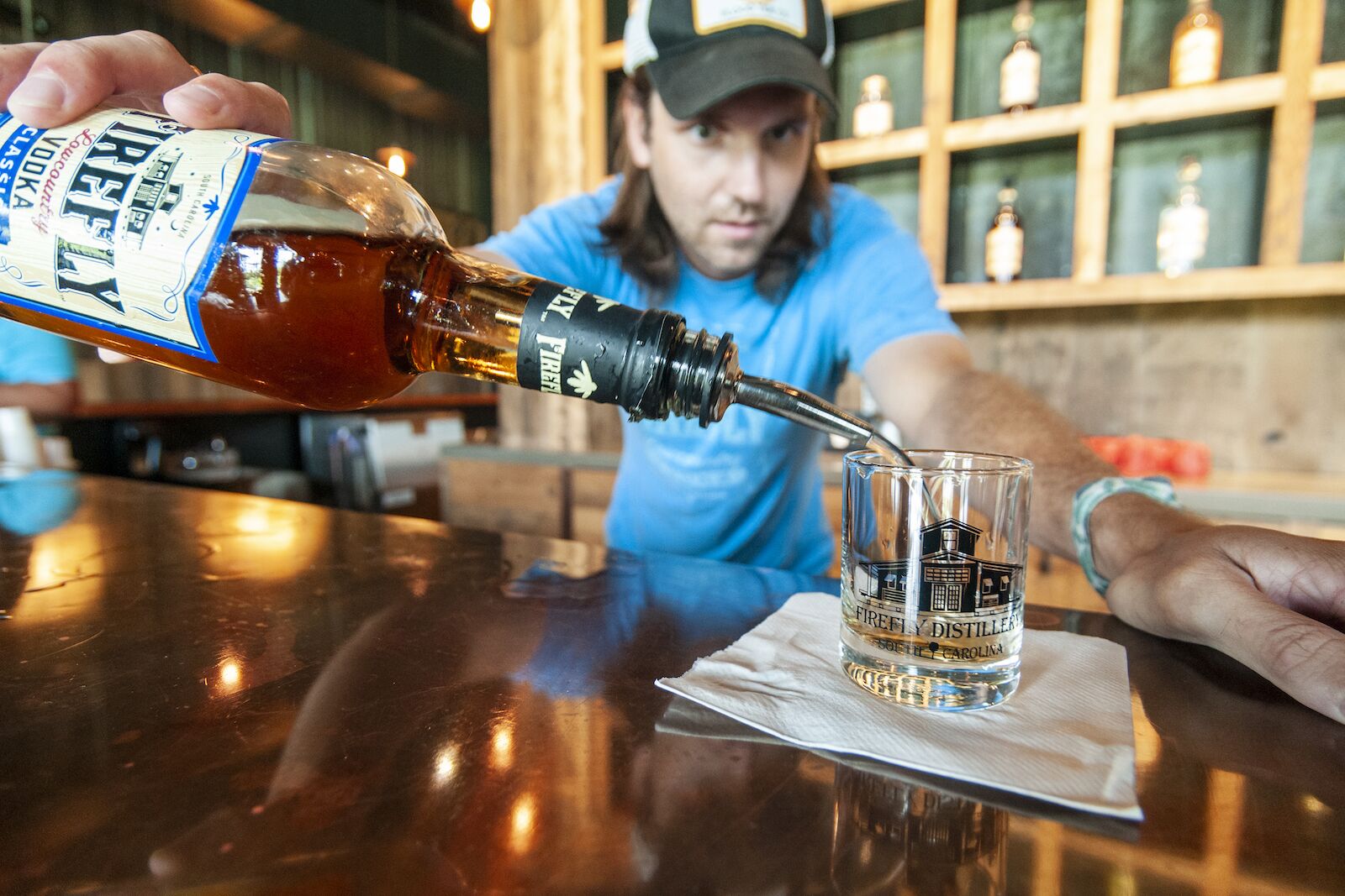 Bartender Adam Graudin pours a sample in the Tasting Room at Firefly Distillery in North Charleston, South Carolina