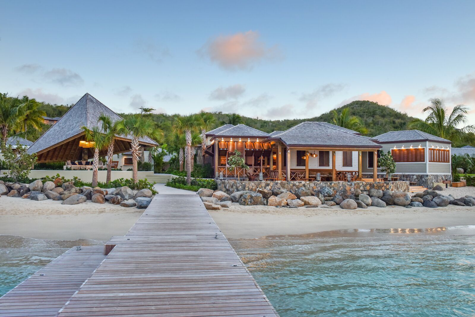 View of the Rosewood Little Dix Bay docks at dusk